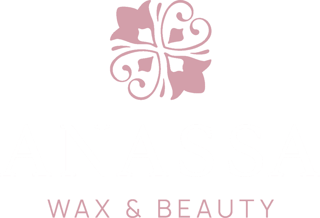 Logo for ANASSA Wax & Beauty with a pink floral graphic above the brand name. The text is in elegant, pale pink and white font on a light background.